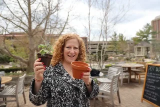 UW-Madison Chancellor Jennifer Mnookin showing a plant and pot from a plant swap at Earth Fest.