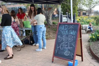A sign at Earth Fest promoting a workshop where participants could build their own bee hotel.