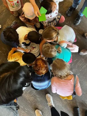 ef-2024-5 An overhead view of students crowding around a crafting project at Earth Fest.