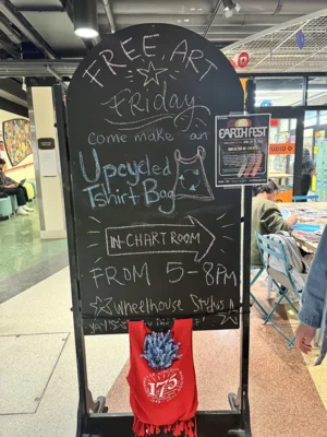 ef-2024-9 A sign promoting Free Art Friday and a chance to make an upcycled T-shirt bag at Earth Fest.